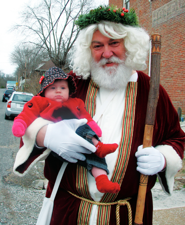old saint nick holding a baby at maeystown illinois old fashioned german christmas