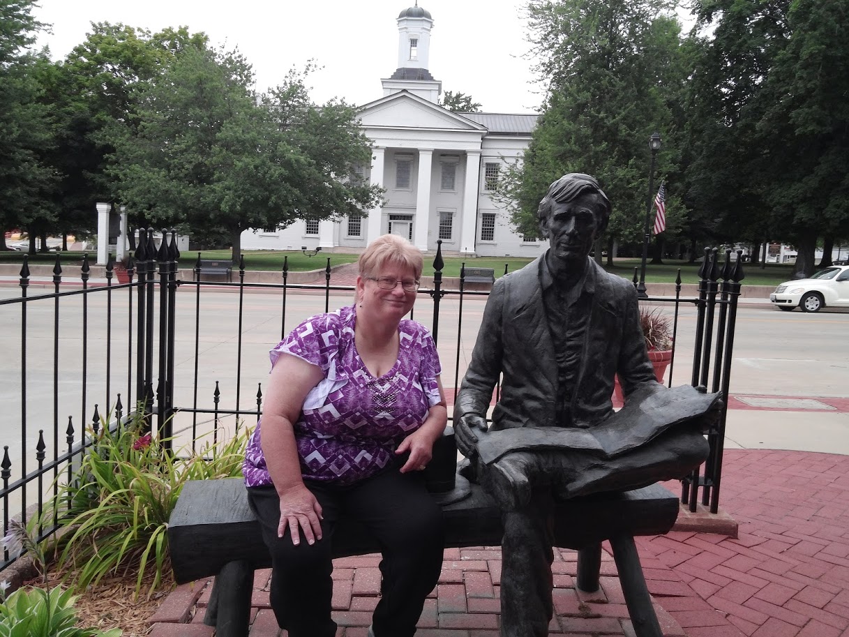 woman sitting next to vandalia statehouse abraham lincoln statue